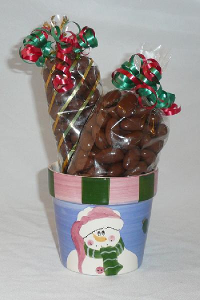 Round Snowman - A cute snowman pot filled with  pound of chocolate covered caramel corn and  pound of chocolate covered almonds decorated with festive colored ribbons.